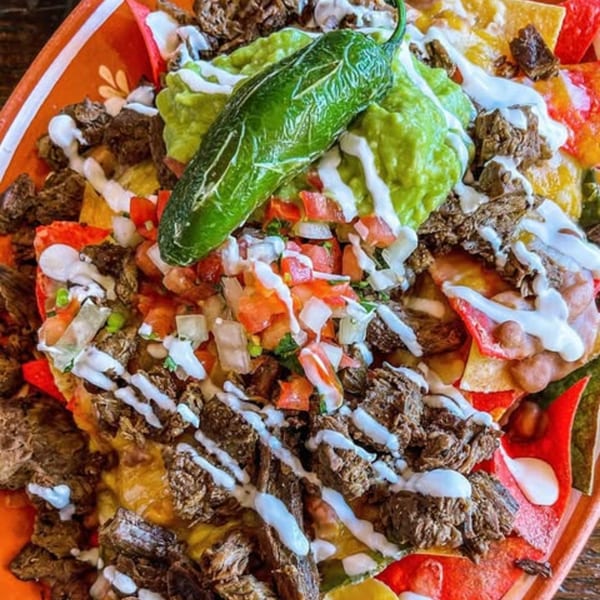 La Chancla Mexican Grill's loaded nachos with steak, guacamole, pico de gallo, sour cream, and a jalapeño.