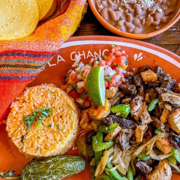 La Chancla Mexican Grill's fajita plate with rice, beans, tortillas, and a grilled jalapeño.
